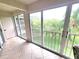 Screened patio featuring tiled floors, a ceiling fan, and a view of greenery at 6507 Stone River Rd # 302, Bradenton, FL 34203