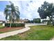 The community pool is surrounded by green lawn and mature shade trees at 6507 Stone River Rd # 302, Bradenton, FL 34203
