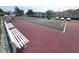 Wide angle view of the community tennis court with well-maintained surface and surrounding landscaping at 6507 Stone River Rd # 302, Bradenton, FL 34203