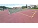 The community tennis court has a well-maintained surface with trees and building views in the background at 6507 Stone River Rd # 302, Bradenton, FL 34203