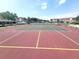 View of the community tennis court, showing the well-maintained surface and nearby buildings at 6507 Stone River Rd # 302, Bradenton, FL 34203