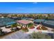 Aerial view of tennis courts with a covered pavilion, parking, and surrounding landscaping at 6512 Grand Estuary Trl # 101, Bradenton, FL 34212