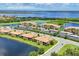 Aerial view of the community with a large lake and mature landscaping at 6512 Grand Estuary Trl # 101, Bradenton, FL 34212