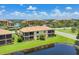 Aerial view of two-story homes with screened patios and community ponds at 6512 Grand Estuary Trl # 101, Bradenton, FL 34212