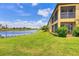 Manicured lawn leading to a community pond at 6512 Grand Estuary Trl # 101, Bradenton, FL 34212