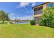 Serene backyard with a screened lanai, expansive lawn, and picturesque pond view at 6512 Grand Estuary Trl # 101, Bradenton, FL 34212