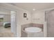 Corner soaking tub in bathroom with tile surround at 6512 Grand Estuary Trl # 101, Bradenton, FL 34212
