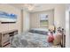 Bedroom featuring twin beds, a ceiling fan, and a window with blinds at 6512 Grand Estuary Trl # 101, Bradenton, FL 34212