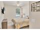 Bedroom featuring ceiling fan, mounted TV, and large window at 6512 Grand Estuary Trl # 101, Bradenton, FL 34212