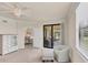 Bright bedroom boasts a ceiling fan, large window, and sliding glass doors to the patio at 6512 Grand Estuary Trl # 101, Bradenton, FL 34212