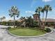 Picturesque view of the community clubhouse entrance with circular driveway and manicured lawn at 6512 Grand Estuary Trl # 101, Bradenton, FL 34212
