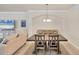 Formal dining room has a large table and neutral decor with a large TV at 6512 Grand Estuary Trl # 101, Bradenton, FL 34212