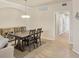Open dining room with large table, neutral paint, and view of hallway at 6512 Grand Estuary Trl # 101, Bradenton, FL 34212