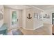 Bright foyer features an accent table, nautical decor, and tile flooring at 6512 Grand Estuary Trl # 101, Bradenton, FL 34212