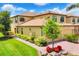 Stunning exterior view of a well-maintained home with lush landscaping at 6512 Grand Estuary Trl # 101, Bradenton, FL 34212
