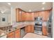 The kitchen shows stainless steel appliances, granite countertops, and wooden cabinetry at 6512 Grand Estuary Trl # 101, Bradenton, FL 34212