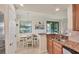 Bright kitchen features granite counters, wooden cabinetry, and a dining area at 6512 Grand Estuary Trl # 101, Bradenton, FL 34212