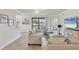 Bright living room features neutral tones, comfortable seating, and a view of the outdoors at 6512 Grand Estuary Trl # 101, Bradenton, FL 34212