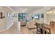 Open-concept living room featuring neutral walls and furniture with view of lanai at 6512 Grand Estuary Trl # 101, Bradenton, FL 34212