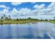 Scenic view of a tranquil pond reflecting a blue, cloudy sky in a residential community at 6512 Grand Estuary Trl # 101, Bradenton, FL 34212