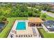 Aerial view of a community pool with lounge chairs, tables and a covered seating area at 6512 Grand Estuary Trl # 101, Bradenton, FL 34212