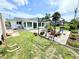 Expansive backyard with patio, pergola and home with light-filled sunroom addition at 8509 La Boca Ave, North Port, FL 34287