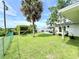 Large backyard with patio, mature trees, sunny lawn and fenced perimeter at 8509 La Boca Ave, North Port, FL 34287