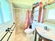 Bathroom featuring tiled shower, decorative mirror and storage, and tiled floor at 8509 La Boca Ave, North Port, FL 34287