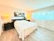 Bright bedroom featuring wood floors, large closet, and comfortable bed with modern black nightstands at 8509 La Boca Ave, North Port, FL 34287
