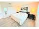 Bedroom featuring wood floors, large closet, and comfortable bed with modern black nightstands at 8509 La Boca Ave, North Port, FL 34287