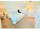 Cozy bedroom featuring soft carpet, comfortable bed with blue pillows, and ample natural light at 8509 La Boca Ave, North Port, FL 34287