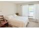 Cozy bedroom featuring a full bed, plush carpet, natural light, and neutral decor at 8509 La Boca Ave, North Port, FL 34287