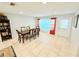 Bright dining area with tile flooring, dining table, and backyard access, creating an inviting space for meals and gatherings at 8509 La Boca Ave, North Port, FL 34287