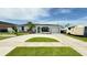 Well-maintained single-story home with a spacious driveway, lush lawn, and vibrant landscaping creating an inviting curb appeal at 8509 La Boca Ave, North Port, FL 34287