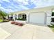 Charming home featuring an attached garage and beautiful flower beds that accentuate the property's curb appeal at 8509 La Boca Ave, North Port, FL 34287