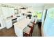 Bright eat-in kitchen with white cabinets, granite countertops, and stainless steel appliances at 8509 La Boca Ave, North Port, FL 34287