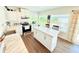 Eat-in kitchen featuring an island, white cabinetry, granite countertops, and lots of natural light at 8509 La Boca Ave, North Port, FL 34287