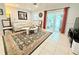 Cozy living room with tile flooring, comfortable seating, and sliding door access, creating a seamless indoor-outdoor flow at 8509 La Boca Ave, North Port, FL 34287