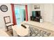 Cozy living room featuring a TV, access to a sliding glass door, and neutral decor at 8509 La Boca Ave, North Port, FL 34287
