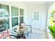 Inviting porch view showcasing outdoor seating and ample natural light, creating a welcoming and serene entry to the home at 8509 La Boca Ave, North Port, FL 34287