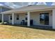 Covered back porch with ceiling fans and tile floor is perfect for entertaining or relaxing outdoors at 931 Signet Dr, Apollo Beach, FL 33572