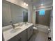 Bright bathroom features double vanity with stone countertop and a shower-tub combo with tile surround at 931 Signet Dr, Apollo Beach, FL 33572