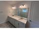 Bathroom features a double sink vanity with quartz counters and a glass shower at 931 Signet Dr, Apollo Beach, FL 33572