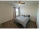 Bedroom with ceiling fan, carpet, and window with curtains at 931 Signet Dr, Apollo Beach, FL 33572