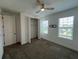 Bedroom features carpeted floors, a ceiling fan, and a closet with folding doors at 931 Signet Dr, Apollo Beach, FL 33572