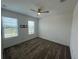 Bedroom with carpet, ceiling fan, and large windows with blinds for natural light at 931 Signet Dr, Apollo Beach, FL 33572