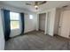 Bedroom with carpet, closet with folding doors, window with curtains and outdoor views at 931 Signet Dr, Apollo Beach, FL 33572