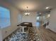 Bright dining area with wood-look floors and a dark wood table, complemented by natural light at 931 Signet Dr, Apollo Beach, FL 33572