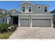 Charming two-story home with gray siding, dual garage and a brick paver driveway at 931 Signet Dr, Apollo Beach, FL 33572