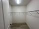 Spacious walk-in closet with wire shelving for optimal organization and wood-look flooring at 931 Signet Dr, Apollo Beach, FL 33572